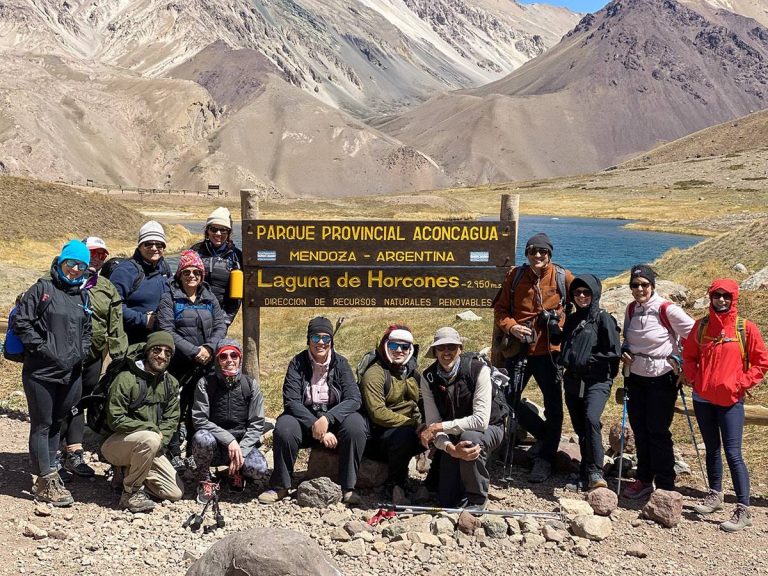 What is an Ecotour? 18 group of guests posing by sign in argentina 1