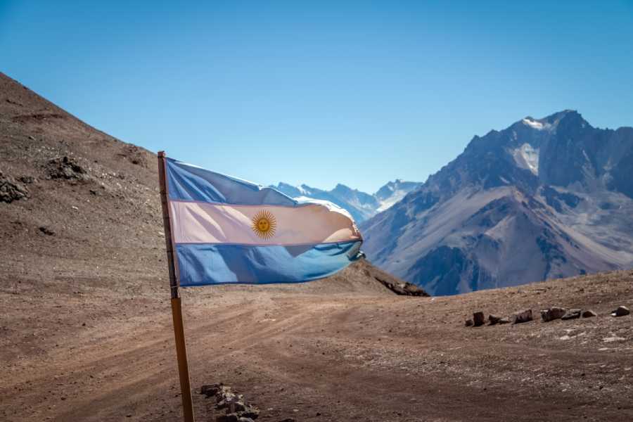 Discover Patagonia and Mendoza: Argentina’s Top Travel Regions 2 Argentina flag on mountain