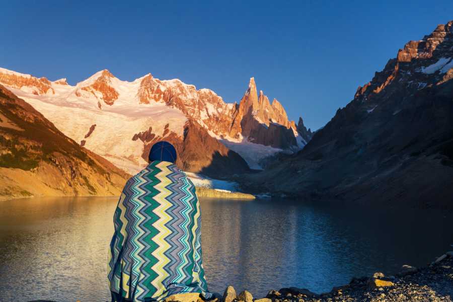 How to Choose the Best Argentina Tours for Your Next Adventure 2 man sitting by lake in Argentina Mountains