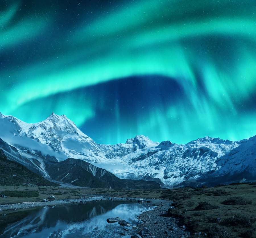 Chase the Aurora in Anchorage: Northern Lights in the City 4 The northern lights over mountains
