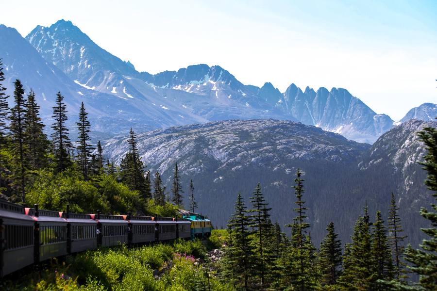 Best Train Tours to Experience in Alaska 4 train going through moutains in Alaska
