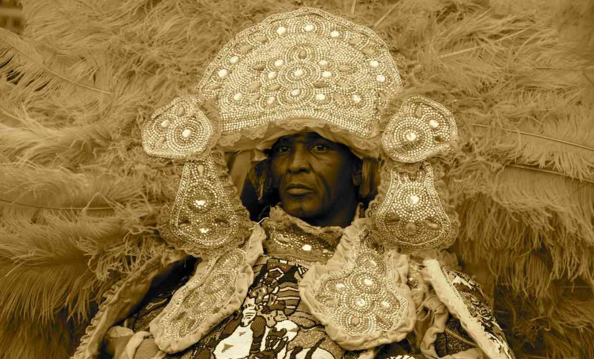 Exploring Louisiana: Be Transported to Another Country 2 A person wears traditional festival costume of a large beaded headers with long feather plumes